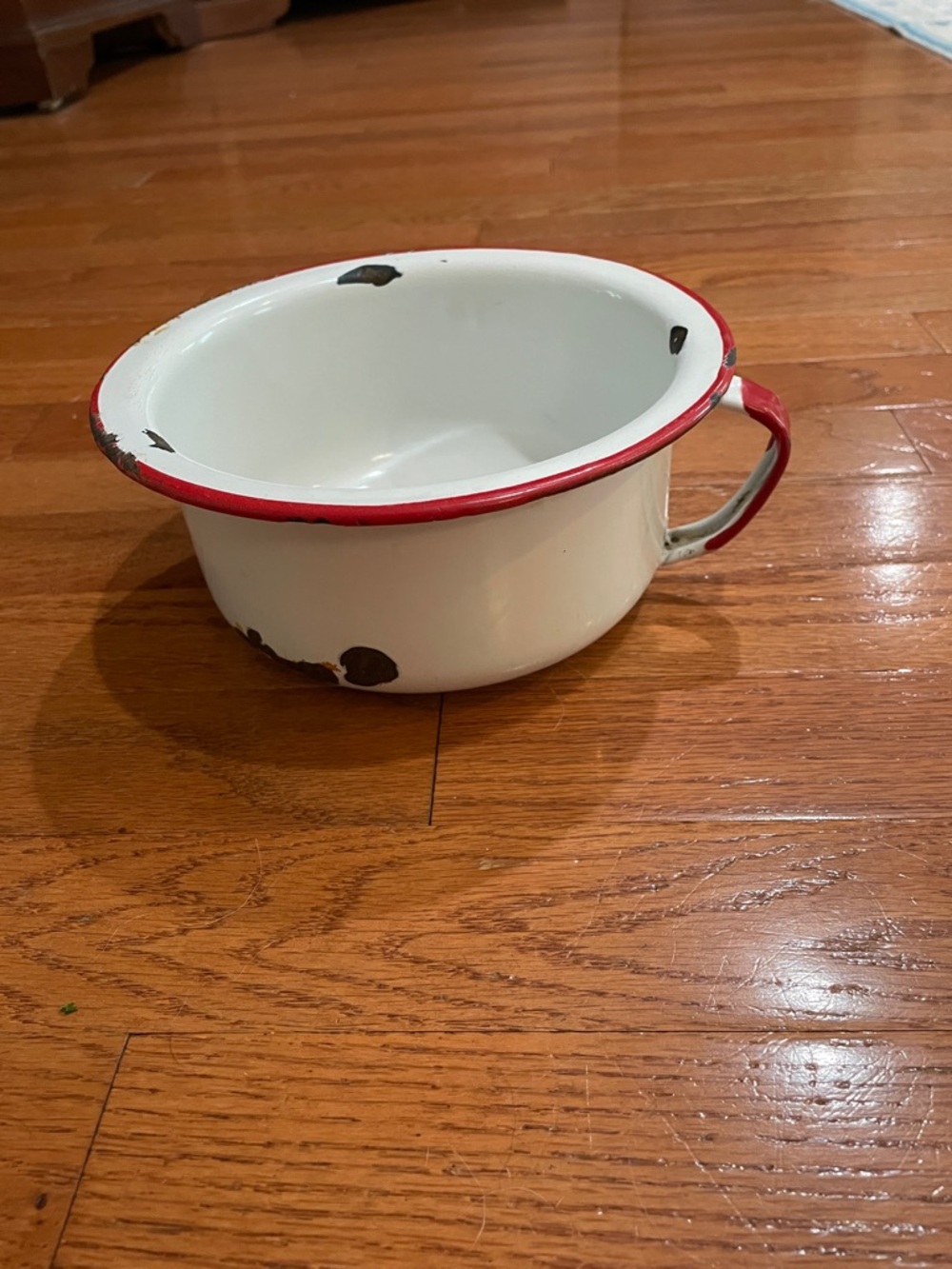 White w/red trim vintage handle pot with peeled paint distressing